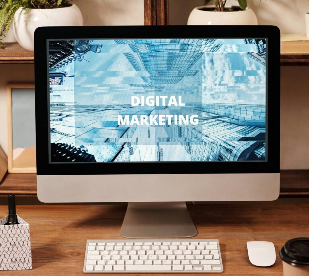 Contemporary office setup featuring digital marketing strategy on a computer screen, ideal for business technology themes.